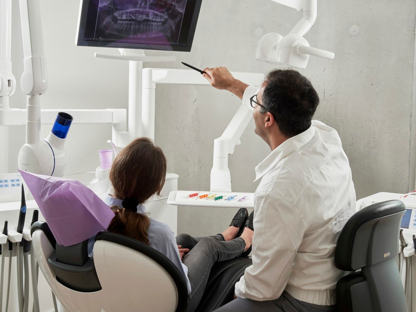 A dentist working chairside with a patient